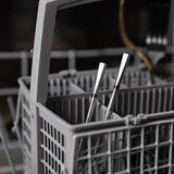 Dishwasher meater in rack with cutlery inside, blurred kitchen background